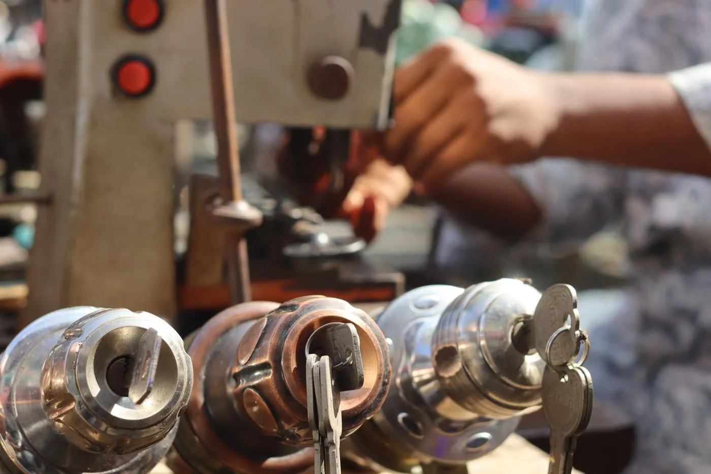 Locksmith resetting the pins inside a lock cylinder at a workbench